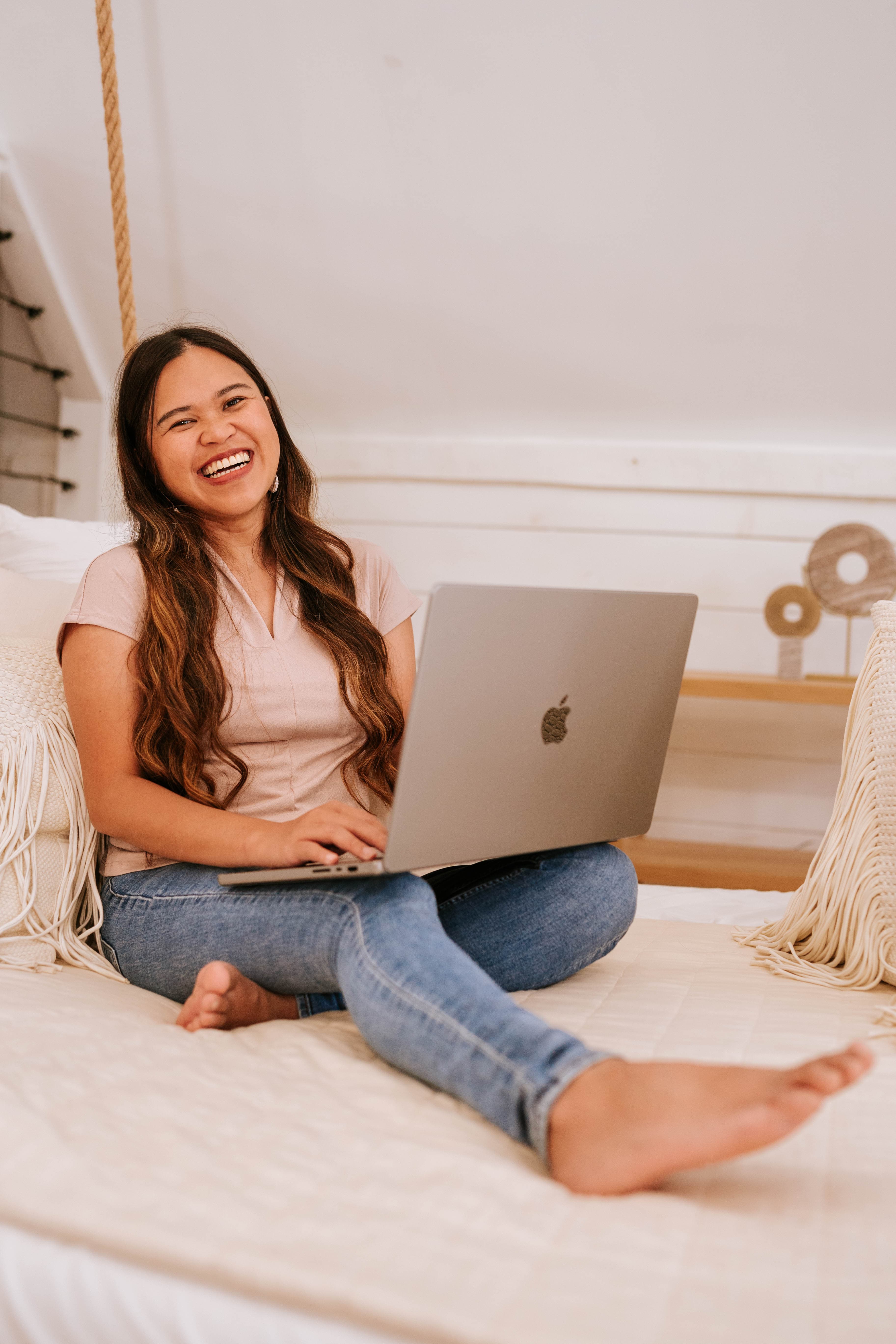 Kristy Yoder laughing while working on her laptop